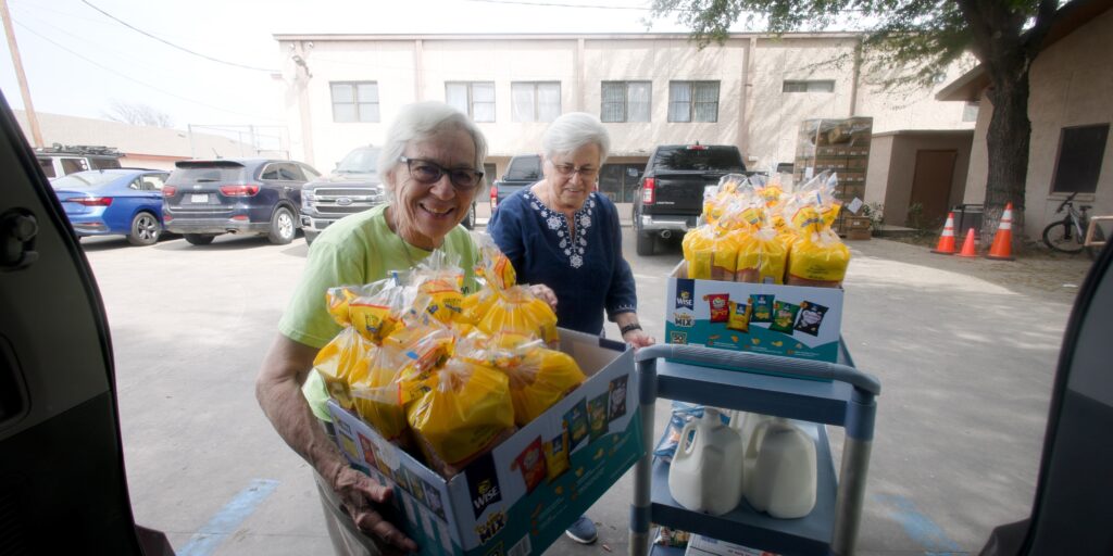 Sister Roseanne and Sister Joyce unload food as they serve migrants and asylum-seekers with Catholic Charities Diocese of Laredo