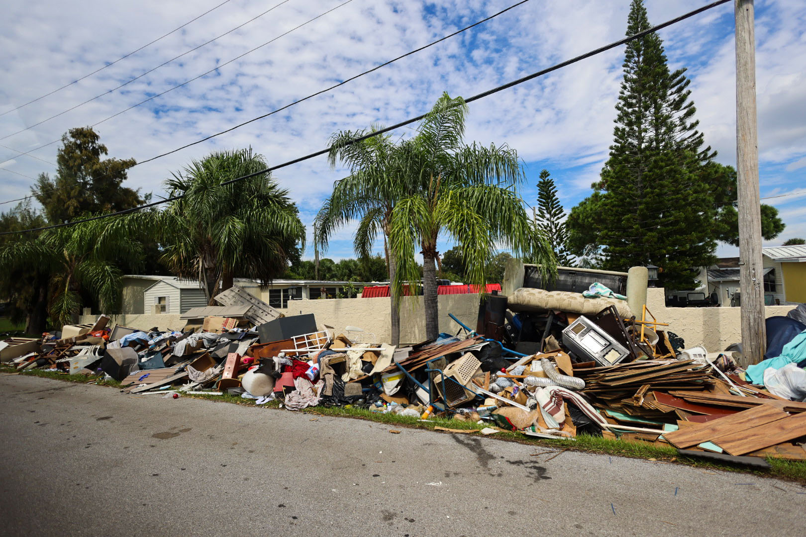 Cleanup has begun in Hurricane Helene-ravaged Tampa, with households already piling ruined belongings and building materials, including furniture, flooring and appliances at their curbs.