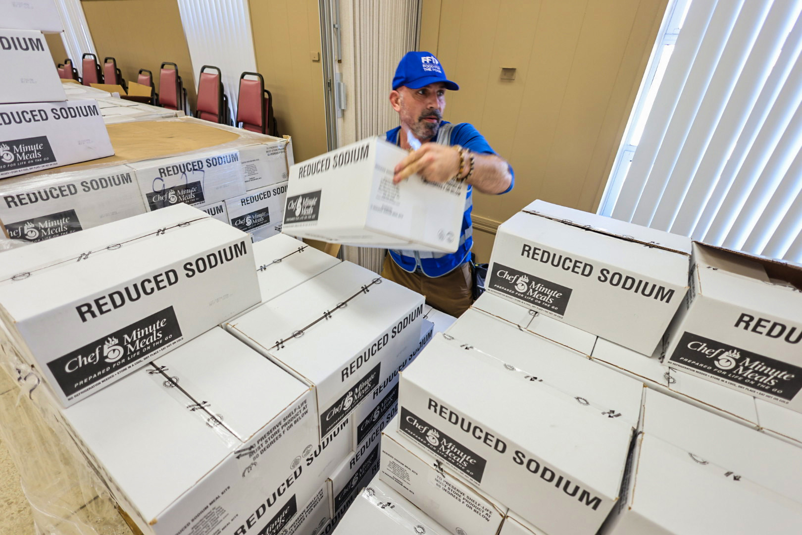 Prepared foods are sorted for distribution at a Catholic Charities Diocese of St. Petersburg location after Hurricane Helene.