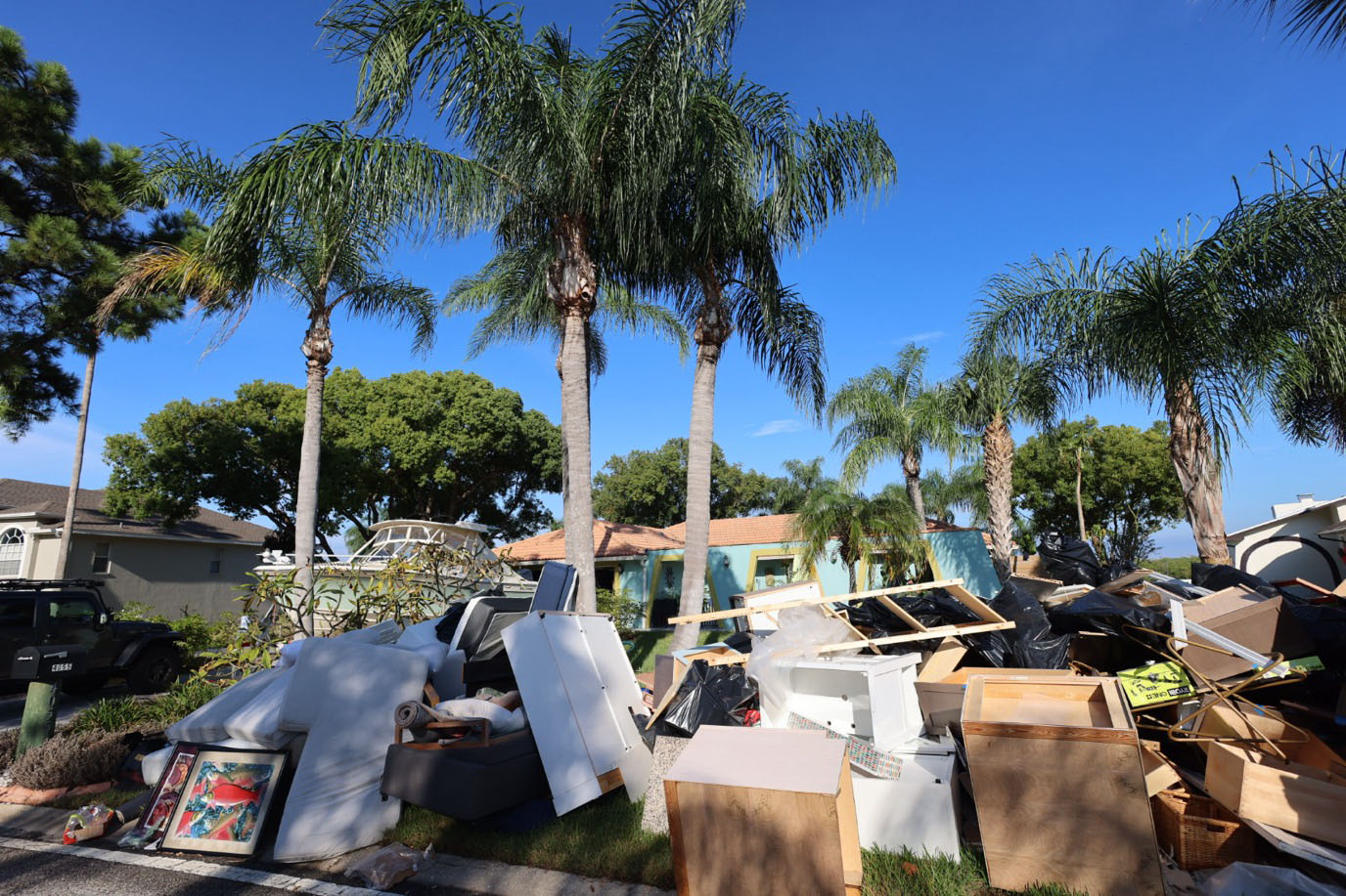 Cleanup has begun in Hurricane Helene-ravaged Tampa, with households already piling ruined belongings and building materials at their curbs.