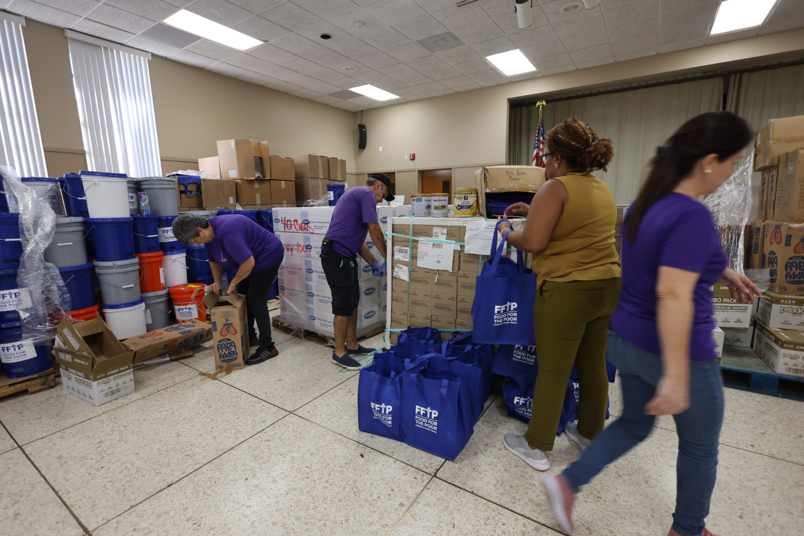 Catholic Charities staff organize supplies for distribution at a Catholic Charities Diocese of St. Petersburg location in Tampa after Hurricane Helene.