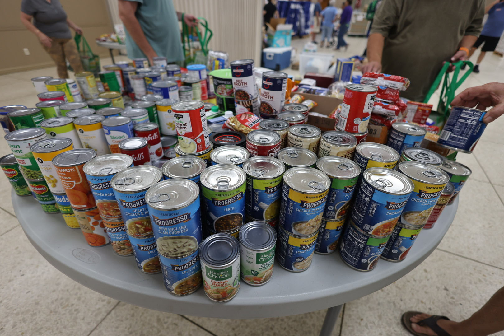 Canned food lay out on a table for distribution at a Catholic Charities Diocese of St. Petersburg location in Tampa after Hurricane Helene.